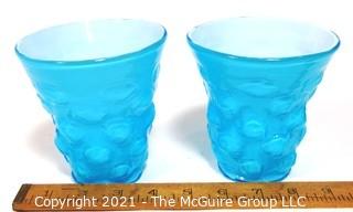 Pair of Blue Hand Blown Glass Beakers Encased In White Made by the Consolidated Glass Co. Measures approximately 5" tall.