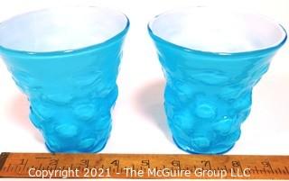 Pair of Blue Hand Blown Glass Beakers Encased In White Made by the Consolidated Glass Co. Measures approximately 5" tall.