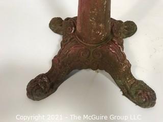 Cast iron Red Painted Stand.  Measures approximately 24" tall.