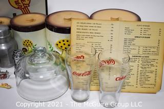 Collection including vintage diner menus, Coca Cola, Aluminum Karo Syrup container, and glass cloche and nesting set of canisters 