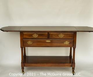 Cherry Buffet by Statton Trutype Americana with Two Drop Leaf Edges above Three Drawers with Lower Exposed Shelf on Castors. 68"W when open and 33"T