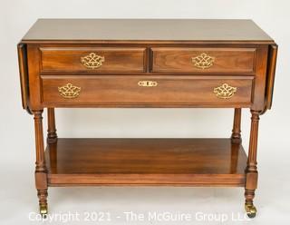 Cherry Buffet by Statton Trutype Americana with Two Drop Leaf Edges above Three Drawers with Lower Exposed Shelf on Castors. 68"W when open and 33"T