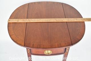 Sheraton Style Pembroke Mahogany Drop Leaf Table with Satinwood Inlay, made by Councill;  25"T and extends to 29"W with leaves up.