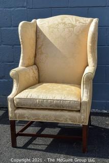 Yellow Damask Upholstered Wing Back Chair. {Note: repaired leg}