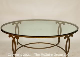 Oval Heavy Gilt Cast Iron Coffee Table with Glass Insert.  Measures approximately 49"long x 34" wide