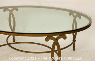 Oval Heavy Gilt Cast Iron Coffee Table with Glass Insert.  Measures approximately 49"long x 34" wide