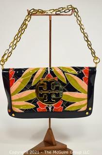 Tory Burch Floral Print Patent Leather Folding Clutch with Chain Strap & Navy Blue Interior.  Measures approximately 12"L x 1"W x 7"H. Comes with its original Tory Burch cloth storage bag.
