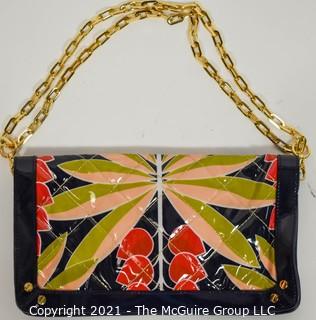 Tory Burch Floral Print Patent Leather Folding Clutch with Chain Strap & Navy Blue Interior.  Measures approximately 12"L x 1"W x 7"H. Comes with its original Tory Burch cloth storage bag.
