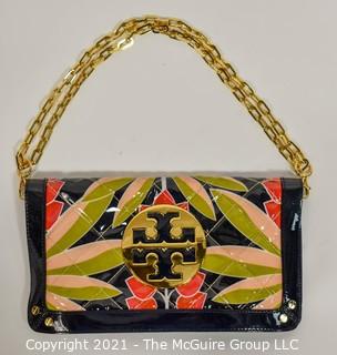 Tory Burch Floral Print Patent Leather Folding Clutch with Chain Strap & Navy Blue Interior.  Measures approximately 12"L x 1"W x 7"H. Comes with its original Tory Burch cloth storage bag.
