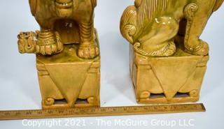 Pair of Heavy O.A.I. Oriental Arts Hong Kong Yellow Glazed Ironstone Foo Dogs; Some wear; Approximately 18.5" tall. 