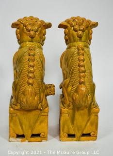 Pair of Heavy O.A.I. Oriental Arts Hong Kong Yellow Glazed Ironstone Foo Dogs; Some wear; Approximately 18.5" tall. 