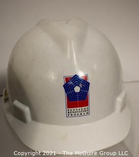 Collection including chess board with wooden pieces, Pentagon Renovation Program Hard Hat and Singaporean Field Hard Hat.  