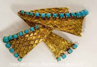 Vintage 18kt Gold Textured Brooch or Pin with Blue Gemstones.   Measures approximately 2" long and 17.6g in weight. 