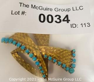 Vintage 18kt Gold Textured Brooch or Pin with Blue Gemstones.   Measures approximately 2" long and 17.6g in weight. 