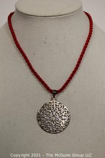 Pierced Sterling Silver Pendant on Red Cord Necklace.  Measures approximately 2" in diameter and 11.2 g weight. 