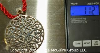 Pierced Sterling Silver Pendant on Red Cord Necklace.  Measures approximately 2" in diameter and 11.2 g weight. 