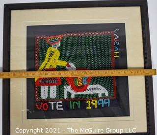 Framed Hand Beaded Fabric Tapestry Laizah IEC Vote 1999.  It measures approximately 23" squre.