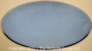 Vintage Oval Shaped Beveled Blue Glass Mirror.  Measures approximately 12 x 16" 