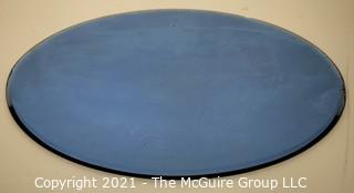 Vintage Oval Shaped Beveled Blue Glass Mirror.  Measures approximately 12 x 16" 