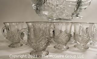 Unmarked Clear Cambridge Glass Swan Punch Bowl with 12 Swan Cups & Ladle. It measures approximately 15 long, 10" tall and 10" wide.  Chip in back tail feather. 