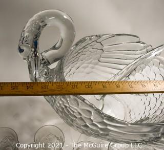 Unmarked Clear Cambridge Glass Swan Punch Bowl with 12 Swan Cups & Ladle. It measures approximately 15 long, 10" tall and 10" wide.  Chip in back tail feather. 