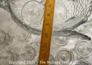 Unmarked Clear Cambridge Glass Swan Punch Bowl with 12 Swan Cups & Ladle. It measures approximately 15 long, 10" tall and 10" wide.  Chip in back tail feather. 