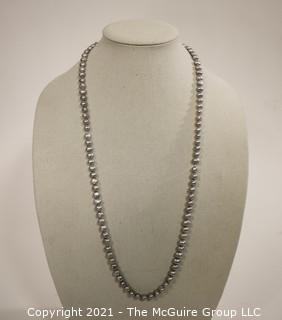 Opera Length Grey Fresh Water Pearl Necklace wih 14 kt Gold Clasp.  Approximately 32" long.