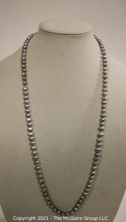 Opera Length Grey Fresh Water Pearl Necklace wih 14 kt Gold Clasp.  Approximately 32" long.