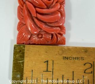 Molded Red Celluloid or Bakelite Clip, Made in Japan. It measures approximately 2" long and 1 1/4" wide.