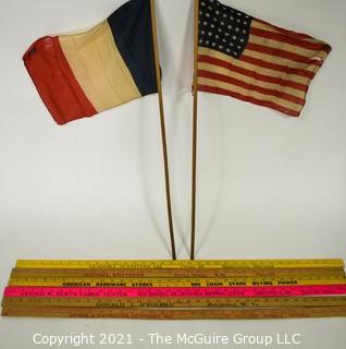 Grouping of six Yard Sticks with Advertising and Vintage French Flag and US Flags (48 stars)