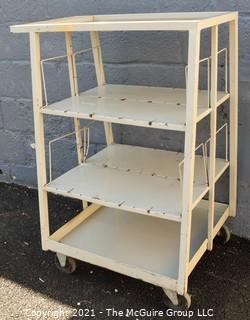 Trapezoidal 4 Shelf Metal Cart with (2) 4" locking swivel castors and 2 fixed; top shelf is 14 x 24" with extending handle; height 40"