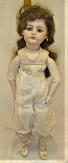 Collectible: Doll: leather and cloth soft body w/ Simon & Halbig German bisque head and socketed shoulders circa 1912 in blue dress