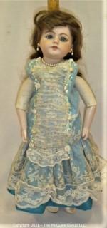 Collectible: Doll: leather and cloth soft body w/ Simon & Halbig German bisque head and socketed shoulders circa 1912 in blue dress