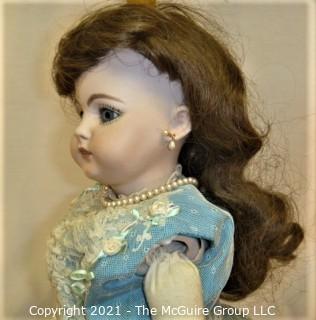 Collectible: Doll: leather and cloth soft body w/ Simon & Halbig German bisque head and socketed shoulders circa 1912 in blue dress