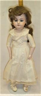 Collectible: Doll: leather and cloth soft body w/ Simon & Halbig German bisque head and socketed shoulders circa 1912 in blue dress