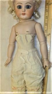 Collectible: Doll: bisque and cloth soft body w/ Simon & Halbig German bisque head and socketed shoulders circa 1912 in pink dress