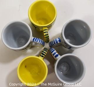 Set of Five (5) Henriot Quimper French Faience Tulip Shaped Mugs in Soleil Yellow and White with Both a Lady & Gentlemen on the Side.  Each measures approximately 4" tall. 