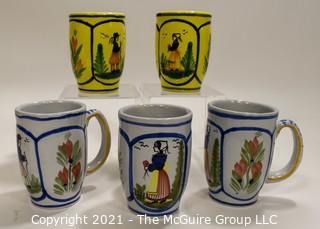 Set of Five (5) Henriot Quimper French Faience Tulip Shaped Mugs in Soleil Yellow and White with Both a Lady & Gentlemen on the Side.  Each measures approximately 4" tall. 