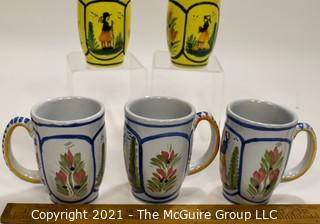 Set of Five (5) Henriot Quimper French Faience Tulip Shaped Mugs in Soleil Yellow and White with Both a Lady & Gentlemen on the Side.  Each measures approximately 4" tall. 