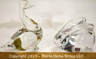 Group of Four (4) Crystal Art Glass Figurines.  Includes Royal Krona Sweden Crystal Art Glass Lead Crystal Penguin Signed By Mats Jonasson, Orrefors Clear Crystal Rabbit Figurine Signed By Artist, Sweden by Granna Glas. Swan & Silvestri Art Glass Clear Sitting Cat . 