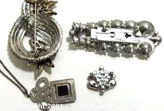 Group of Four (4) Vintage and Modern Rhinestone Encrusted Brooches & Pendants.  One marked Cabi.
