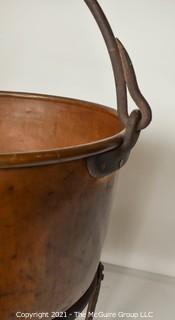 Antique Hammered Large Copper Cauldron with Hand Forged Iron Base and Handle.  Measures 43"T (with handle) x 27" D (at top).  Base Measure 14"T.  Includes wood insert. 