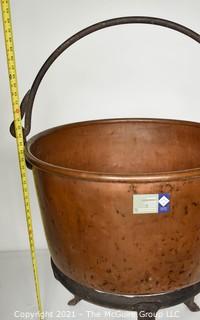 Antique Hammered Large Copper Cauldron with Hand Forged Iron Base and Handle.  Measures 43"T (with handle) x 27" D (at top).  Base Measure 14"T.  Includes wood insert. 