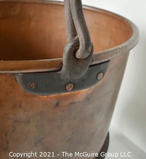 Antique Hammered Large Copper Cauldron with Hand Forged Iron Base and Handle.  Measures 43"T (with handle) x 27" D (at top).  Base Measure 14"T.  Includes wood insert. 