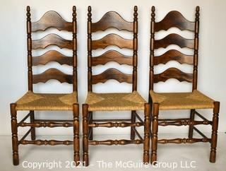 Three (3) Ladder-Back Dining Chairs with Wicker Seats and turned spindle legs