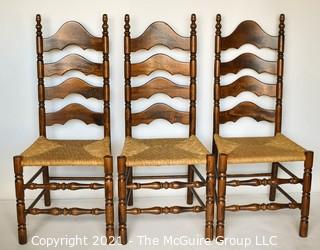 Three (3) Ladder-Back Dining Chairs with Wicker Seats and turned spindle legs