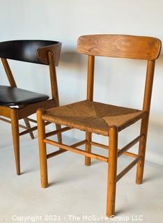 Two (2) Mid Century Modern MCM Dining or Desk Chairs.  One with black vinyl upholstery (burn hole), One with rush seating. 