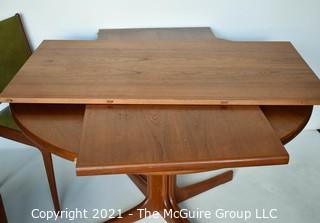 Danish Mid Century Modern MCM Teak Dining Table with Three (3) Chairs and Two (2) Leaves Made By J.O. Carlsson For Vetlanda .  Measures  29"T x 47" D.  Each leaf measures 24"W.