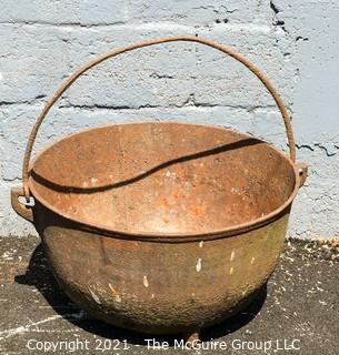 Large Tri-footed Cast Iron Cauldron with Handle.  Drain slot in Base.  Measures 24"D x 14"H.