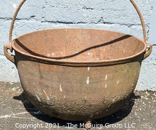 Large Tri-footed Cast Iron Cauldron with Handle.  Drain slot in Base.  Measures 24"D x 14"H.